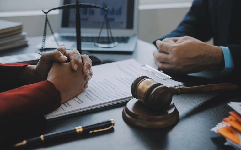 Male judge in a courtroom with the gavel, working with lawyer